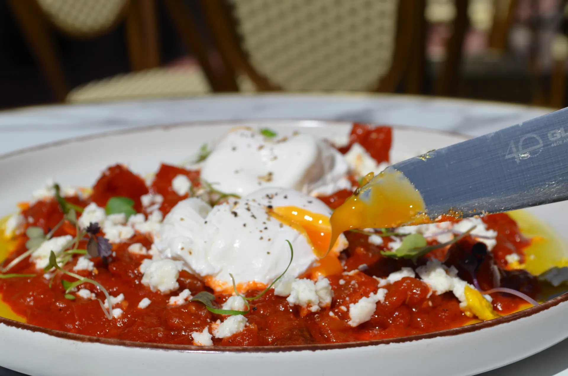 Shakshuka with poached eggs and feta